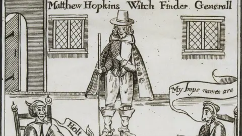 Getty Images A sepia-toned 17th Century woodcut which has written at the top Matthew Hopkins Witch Finder Generall (sic). Hopkins is in the middle wearing a broad-brimmed hat, a jacket and breeches, knee-high boots and a knee-length cloak over the top. On either side of him can be seen the head and shoulders of two seated women. They are in a room with a door on the left and two windows on either side of Hopkins