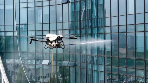 A drone spraying water 