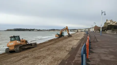 Two diggers on Weymouth beach.