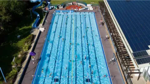 PA Media People swim at Banbury Lido at Woodgreen Leisure Centre in Oxfordshire.