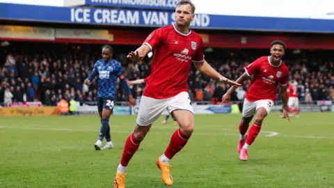 Crewe striker Elliott Nevitt celebrates a goal