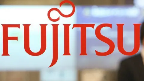 A Fujitsu sign in red letters on a clear background