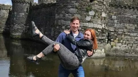 Kyle Whiting Kyle is seen lifting his girlfriend Sasha up in the air outside a castle.