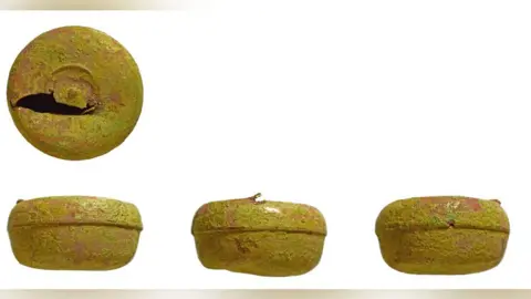 British Museum's Portable Antiquities Scheme Four views of a copper alloy token box, three along the bottom and the fourth above the bottom left hand view. The top view shows the top of the box with a gouge in its lid. The side views all show the top half tightly fitting into the bottom half of the box.