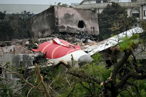 AFP via Getty Images Debris of Air India flight 171 is pictured after it crashed in a residential area near the airport in Ahmedabad on June 13, 2025. Rescue teams with sniffer dogs combed the crash site on June 13 of a London-bound passenger jet which ploughed into a residential area of India's Ahmedabad city, killing at least 265 people on board and on the ground. (Photo by Punit PARANJPE / AFP) (Photo by PUNIT PARANJPE/AFP via Getty Images)