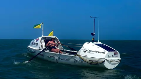 Team Forces/PA Zara rowing in a white rowing boat in the sea