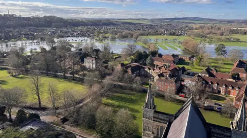 BBC Weather Watchers/Delbert Aerial view of a flat piece of land at Salisbury, showing flooded fields between houses and tree-lined roads.
