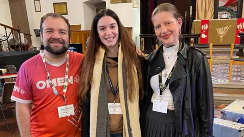 Sam Jaques, Sabrina Ferrazza and Evelina Morkute stand in the knave at St. George's Church, Gravesend