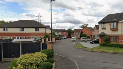 A long residential street with semi-detached houses