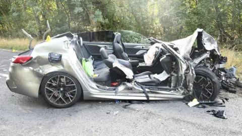 Cambridgeshire Constabulary A seriously damaged silver BMW following a fatal crash