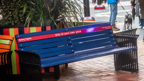 Charter Walk Shopping Centre Bench at the centre reading 'play at your own pace'