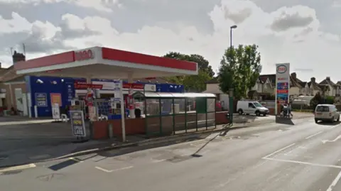 Google An Esso garage is by the side of a road with residential homes in a row behind the garage from a Google streetview screenshot