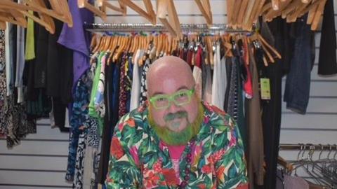 Children's Hospice South West manager standing in front of clothes