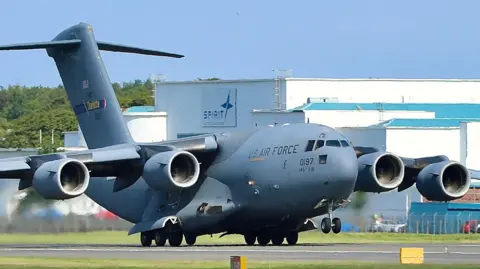 Eddie Wallace A close-up of a US Air Force C-17 plane taxiing along Prestwick Airport's runway, an aircraft hangar behind it