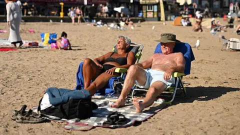 Two older people on a beach 