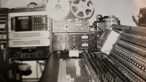 Tiffany Murray A black and white photograph of a recording studio in the 1970s
