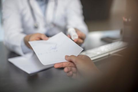 Doctor giving patient a note - stock photo