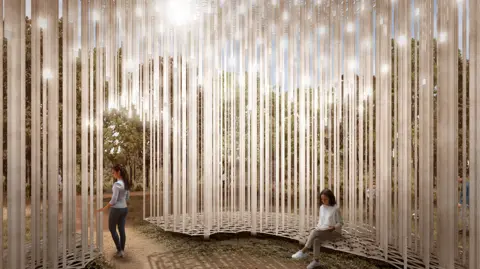 On The Record A CGI from inside a memorial made up of thin aluminium columns. A woman can be seen standing at the entrance while another is sitting down. Trees can be seen outside the memorial.