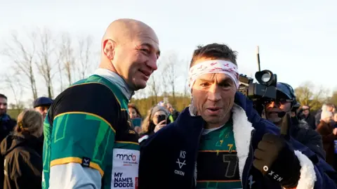 PA Media Steve Borthwick poses with Kevin Sinfield, surrounded by media and crowds at the start to the sixth leg