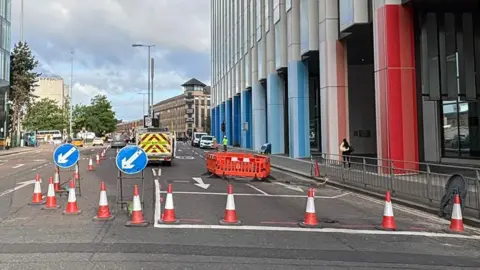 St Vincent Street in Glasgow with the eastbound section blocked off by traffic cones and signs directing traffic