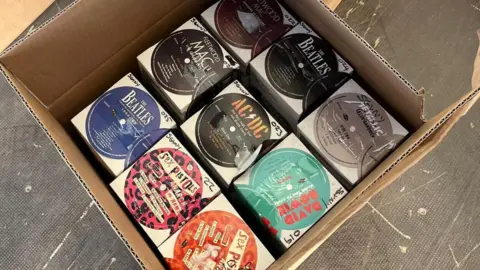 A close up of an opened box seized by police. Inside is counterfeit vinyl from bands including The Beatles, Fleetwood Mac and David Bowie.