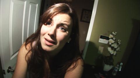 Katie Featherston looking scared in a still from the Paranormal Activity film
