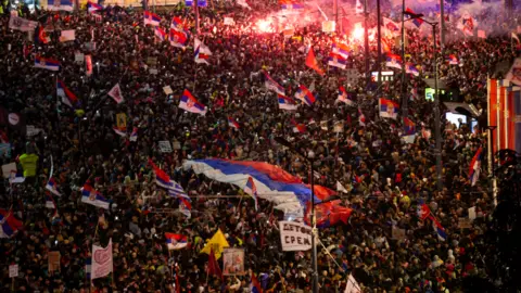 Getty Images Thousands of protesters, some waving flags, take part in one of the largest anti-corruption demonstrations