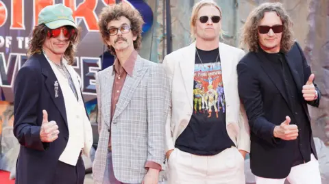 Members of The Darkness posing for a picture at the UK premiere of Masters of the Universe in London. 