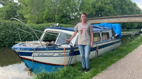BBC Jolita standing next to her boat