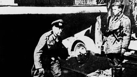 ullstein bild via Getty Images German Nazi General Helmuth Weidling (left) emerges from the bunker to capitulate. Photo: May 1945