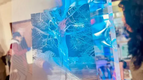 Young at Heart A blue coloured image of a tree. It has the same qualities as a photographic negative but is in vivid blue and on a large clear sheet.