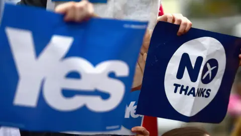Getty Images Close-ups of Yes and No posters being held by supporters campaigning in Drumchapel in September 2014.