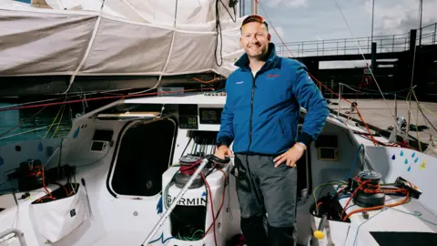 Premier Marinas James Ketchell smiling for a picture on his boat.