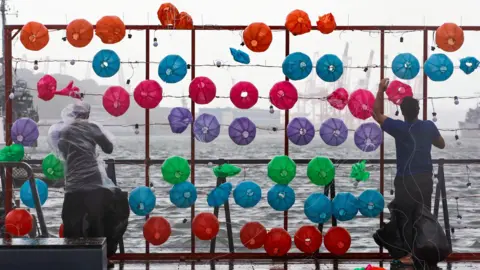 EPA Workers remove lanterns as Storm Gaemi hits Keelung, Taiwan