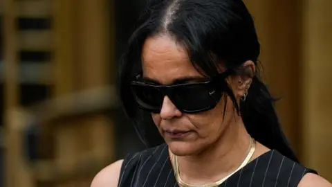 Reuters Capricorn Clark walking out of talk wearing dark sunglasses