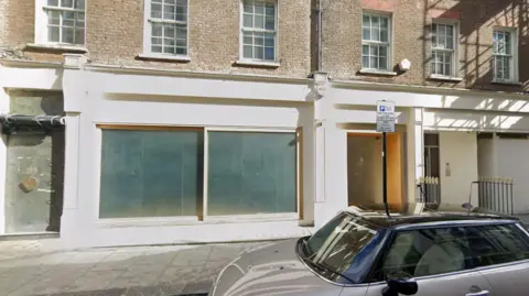 Google A photo of the proposed site at 8-9 Dover Street. The image shows an empty shop window. 