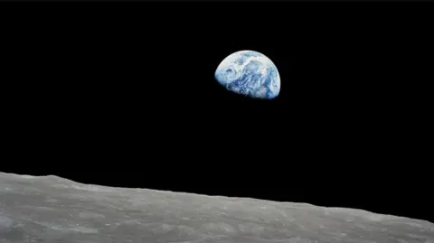 Nasa Earth peaking out behind the Moon in iconic photo