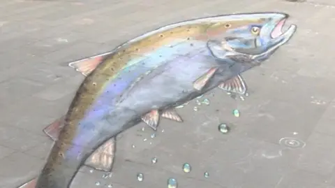 A chalk salmon on a pavement