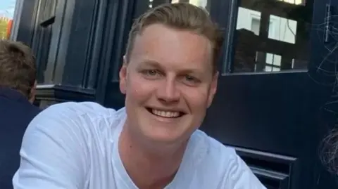 Met Police Edward Pettifer, who was killed in New Orleans on 1 January, pictured wearing a white top and smiling