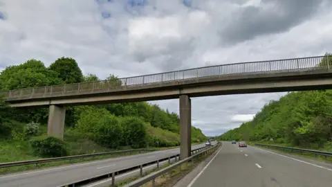 Google A bridge over a dual carriageway road. A second bridge can bee seen further alonf the road