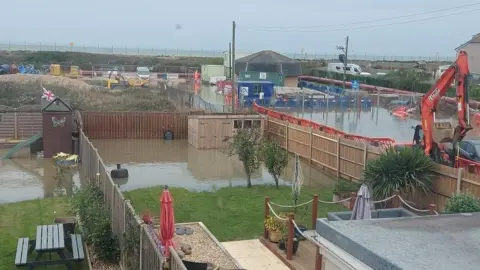 Marjie Hedges A garden flooded with brown water