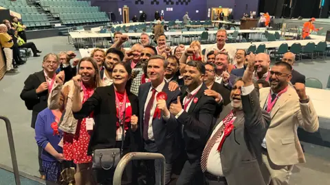 Shariqua Ahmed/BBC Labour supporters celebrating Andrew Pakes' result