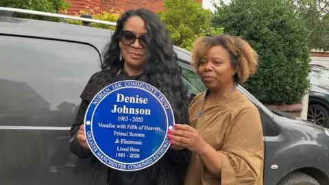 Karen Gabay with Rowetta holding the blue plaque for Denise Johnson