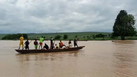 National Emergency Management Agency, Nigeria, via REUTERS People travel by a boat as search and rescue operations continue following a boat accident, in a place given as Sokoto State, Nigeria, in this handout image released on August 17, 2025.