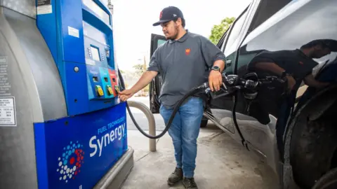 Getty Images Man filling up with gas