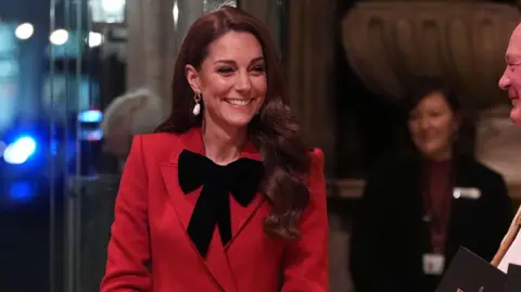 Kate smiling as she enters the event at Westminster Abbey