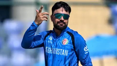 Rashid Khan celebrates taking a wicket by pointing his finger in the air