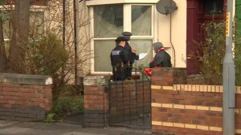 Police conducting interviews along the street