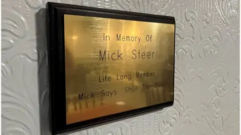 Kevin Shoesmith/BBC A brass plaque to the late Mick Steer