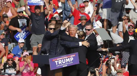 EPA Trump acted defiantly after being hit by a bullet at a rally in July